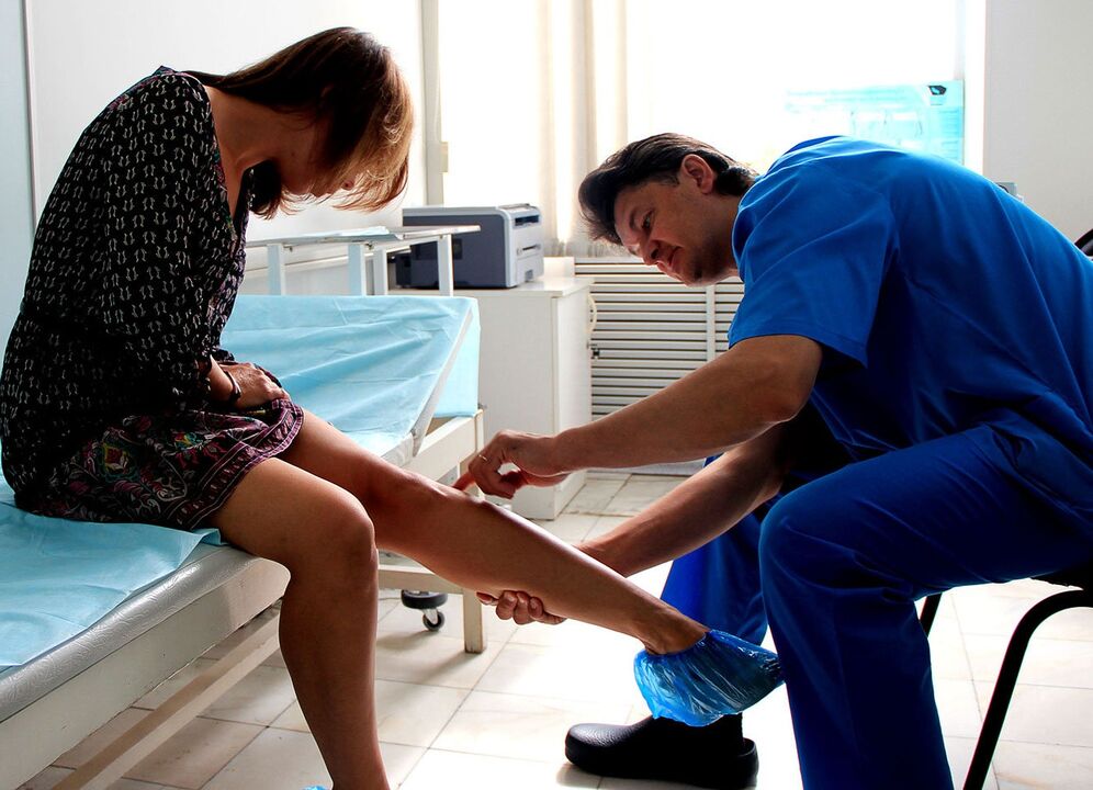 Doctor examining varicose veins